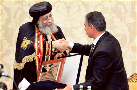 Pope Tawadros II, Pope of Alexandria, is seen receiving a memento from Ehab Hamouda, Egyptian Ambassador to UAE, during his press conference in Abu Dhabi on Tuesday.