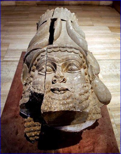 The head of an Assyrian winged bull made out of limestone restored and displayed at the Iraqi National Museum in Baghdad.