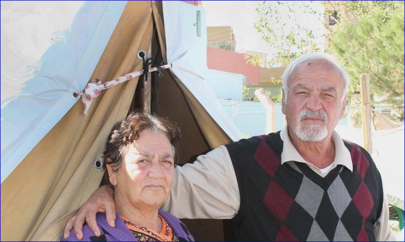 Abu and Um Sabah, pose outside their tent Oct. 26 in a park in Ainkawa, Iraq. One of their sons, Saleh, has traveled to Jordan with his family in the hope of moving elsewhere in the West far from Iraq's continuing violence (CNS photo/Dale Gavlak).