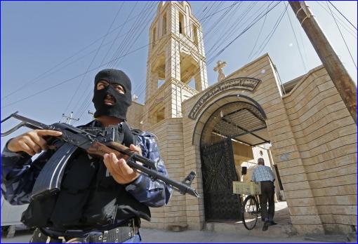 In Iraqi security officer guards a church (Karim Sahib/AFP/Getty Images)