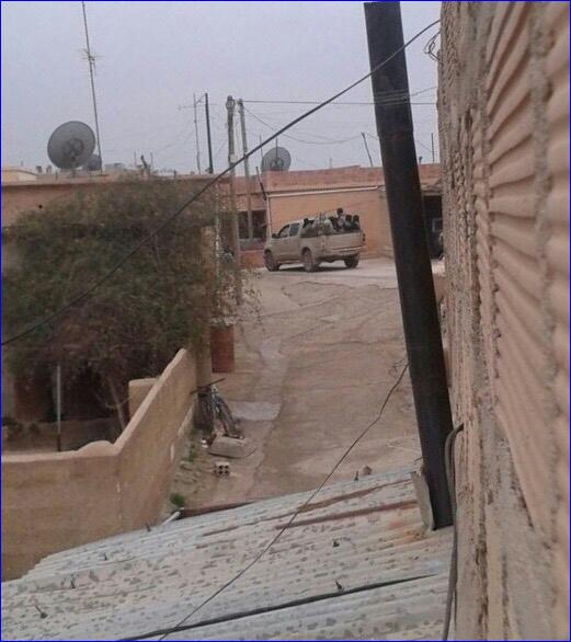 Photo of ISIS members in Tel Hormizd, Syria. ISIS forced the Assyrian residents to remove the cross from the church.