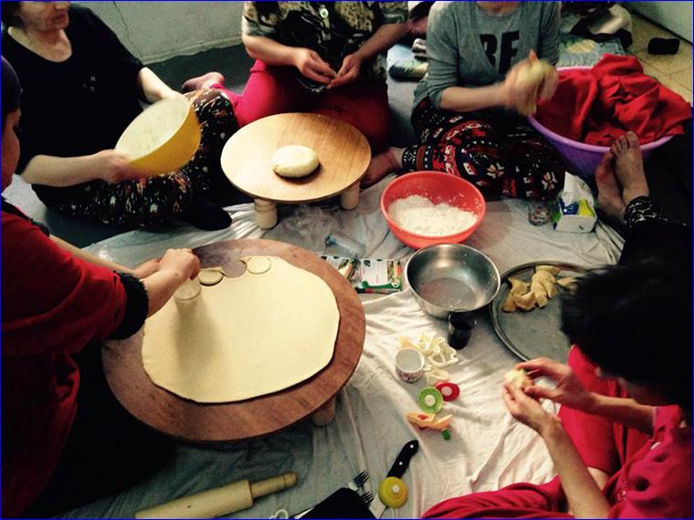 Assyrian women preparing Keleche, a traditional Assyrian pastry.