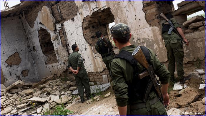 Syriac Military Council members inspect a church which was destroyed when the village was taken over by Jabhat-al Nusra, an al-Qaeda affiliate.