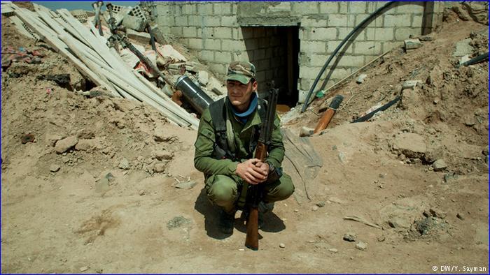 A Syriac Military Council soldier rests in a position overlooking "IS" positions.