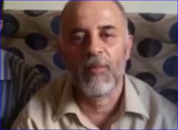 A screen capture from the video, showing one of the Assyrians held by ISIS.