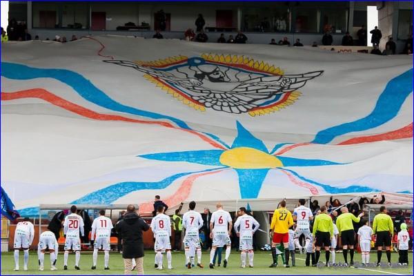 A large Assyrian flag is displayed by Assyrian fans at a game played by Assyriska, an Assyrian football club in Sweden.