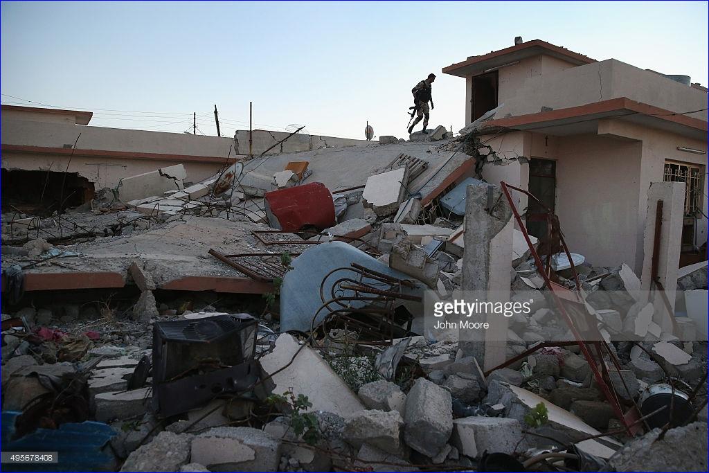 A Christian militiaman patrols through rubble in Telskuf on November 4, 2015 near the frontline with ISIS fighters in Telskuf, northern Iraq. All of the town's 11,000 predominantly Chaldean Catholic residents fled when it was overrun by the Islamic State in 2014 before being retaken by Peshmerga forces. Of the 1,800 families that fled, some 40 percent left Iraq, according to Safaa Khamro, commander of the Nineveh Plain Forces (NPF), Christian militia. Many, he said, have now immigrated to Europe.
