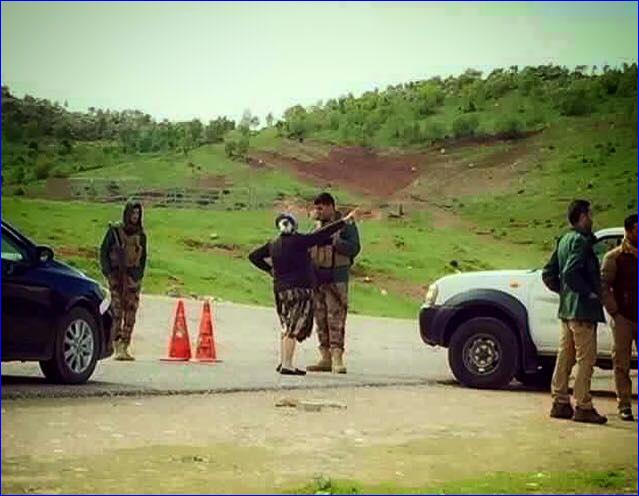 An Assyrian woman confronts a member of the Kurdish security forces in Nahla, who imposed a blockade on the village.