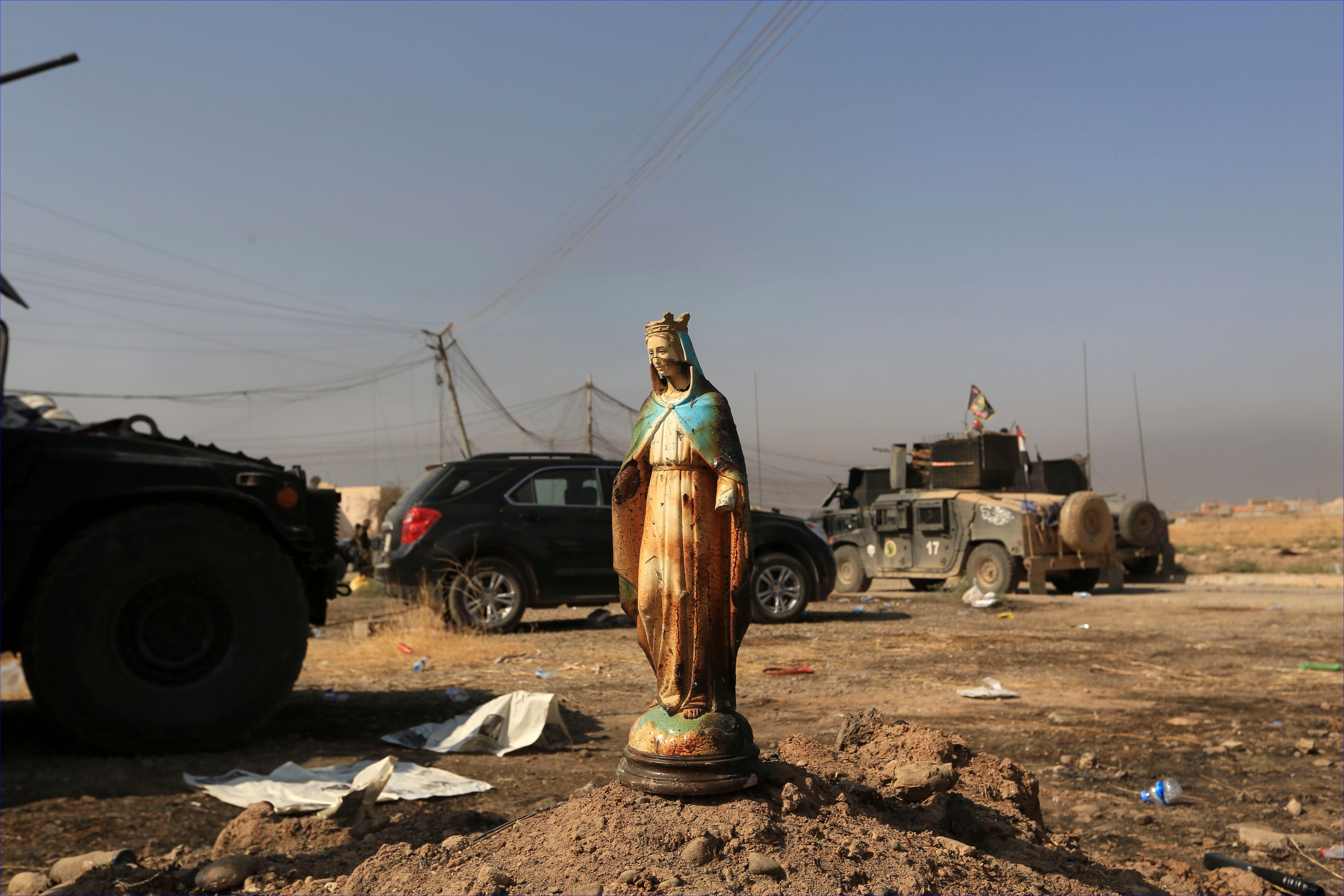 A statue of Virgin Mary is placed in a street in Bartella. Another statue of Mary was found to have been beheaded by ISIS fighters. ( AP/Khalid Mohammed)