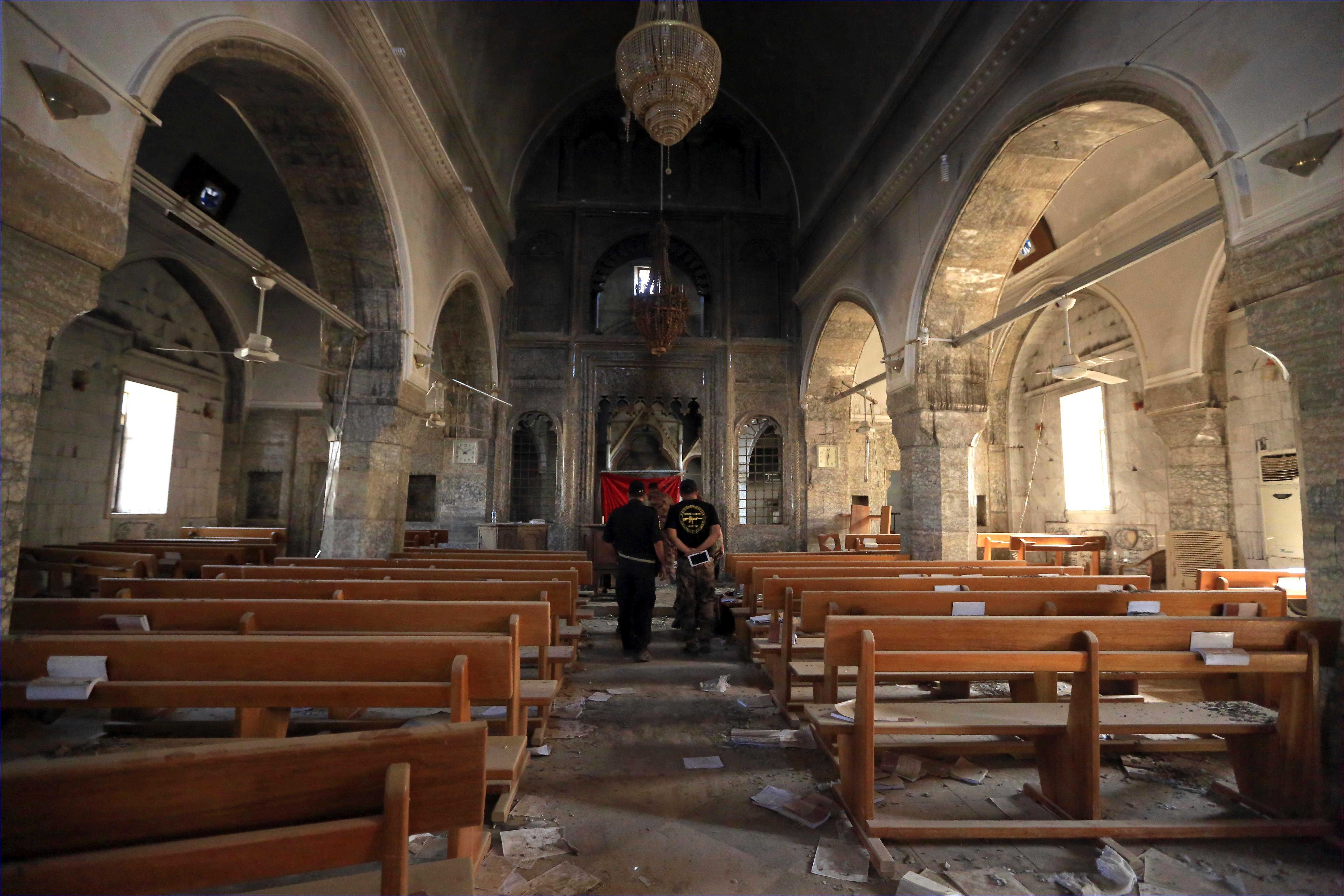 Iraq's elite counterterrorism forces inspect the church of Saint Shmoni, damaged by Islamic State fighters, in Bartella, Iraq, on Oct. 23, 2016. (AP/Khalid Mohammed)