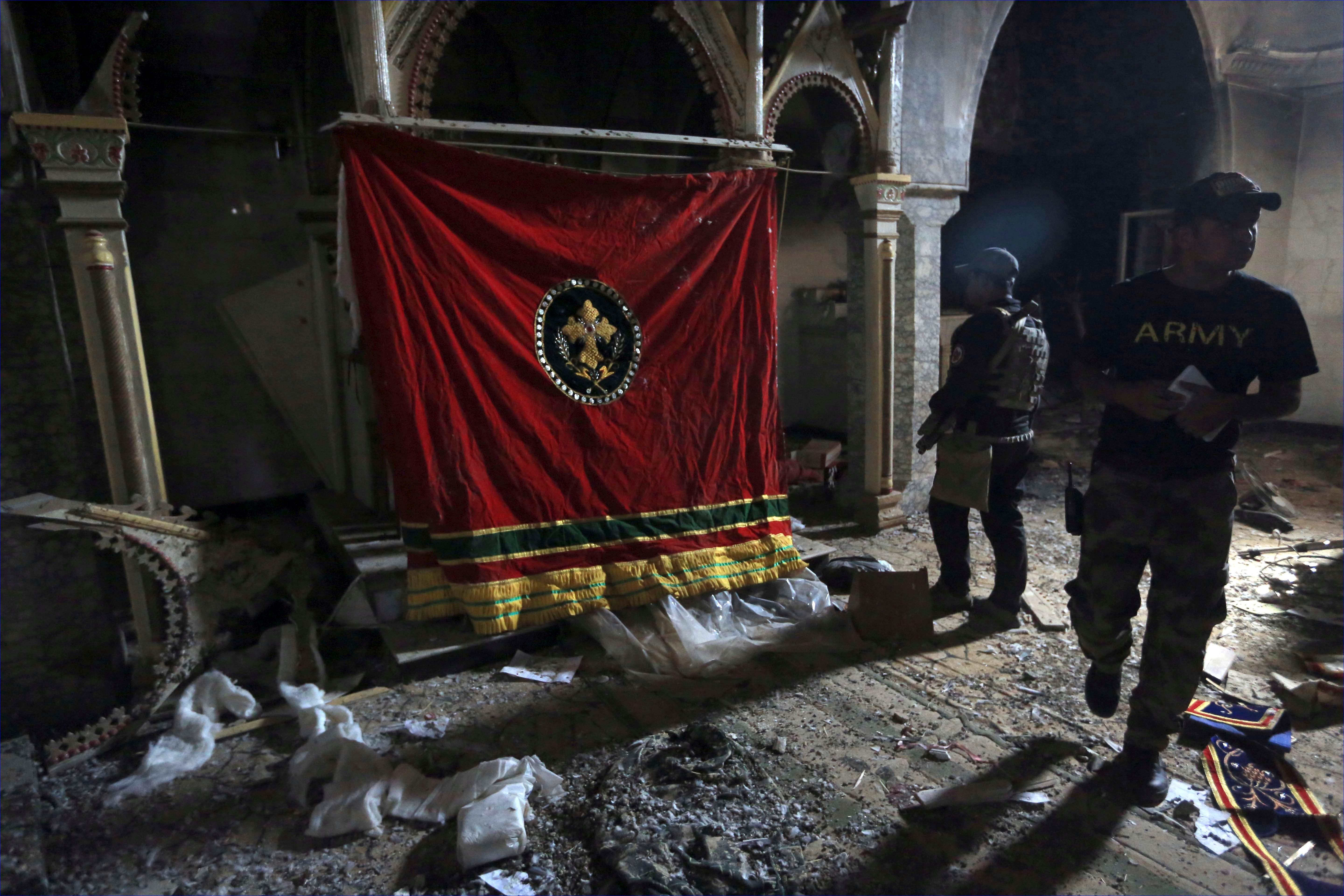 Iraq's elite counterterrorism forces look around the church of Saint Shmoni, ransacked by ISIS. ( AP/Khalid Mohammed)