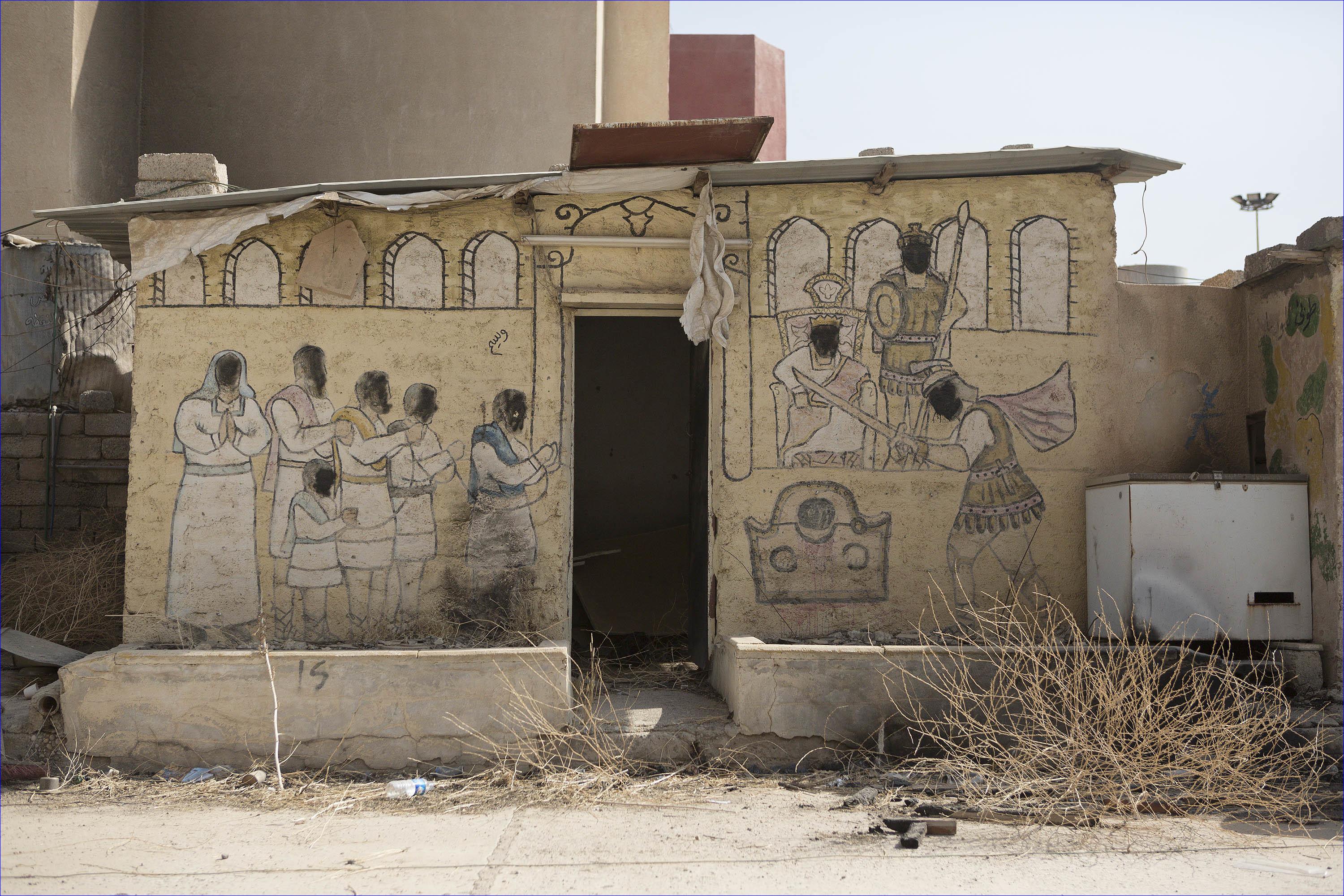 A mural defaced by Islamic State militants is seen outside the Saint Shmoni Church. (Rex Features via AP Images) ( Rex Features/AP)