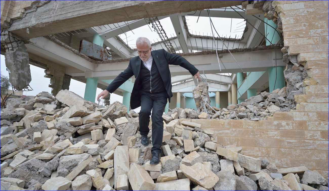 Father Emanuel Youkhana, an archimandrite of the Assyrian Church of the East, walks through the rubble of a demolished church in Mosul, Iraq, Jan. 27. ( CNS/Paul Jeffrey)